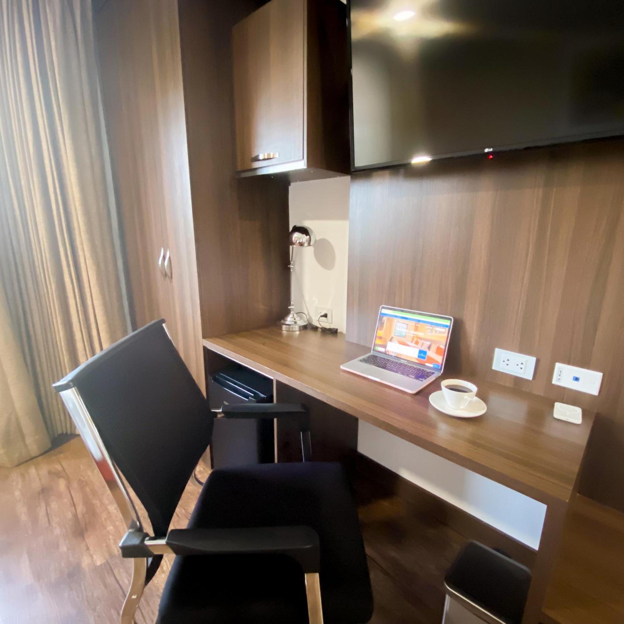 Hotel Royal Elim International Cali Kültér fotó A work desk in a hotel room